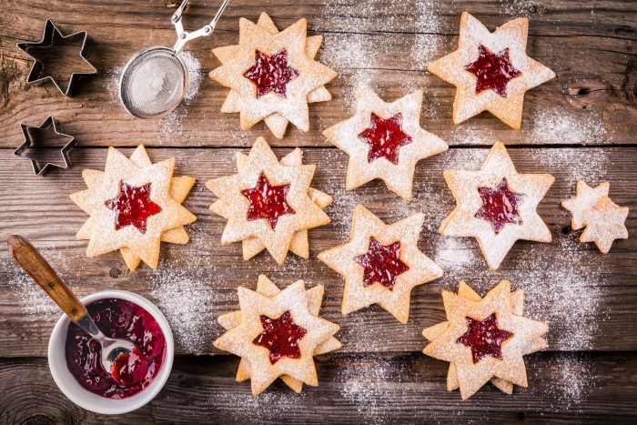 68883693 - christmas linzer cookies with raspberry jam on a rustic wooden background
